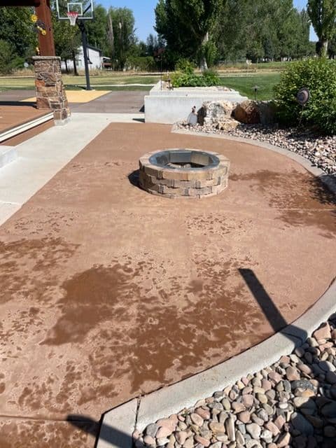 Stamped Concrete Patio with Fire Pit Almost Ready to Shine image