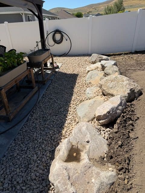 Backyard Gets Structure With a Retaining Wall and Concrete Patio image